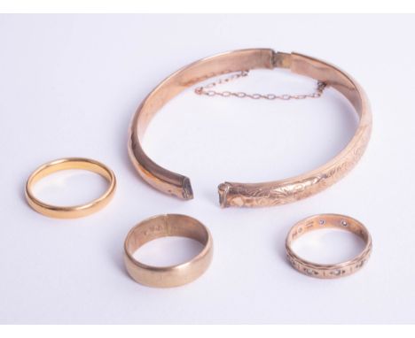 A 9ct broken bangle together with two 9ct wedding bands, approx 9.4g and one 22ct wedding band, approx 5g.