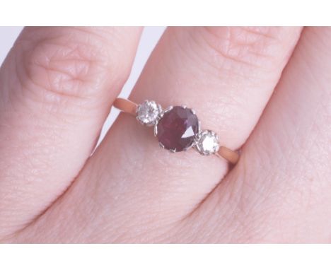 An 18ct ruby and diamond three stone ring size K, being sold to raise money for Dog Rescue Cyprus.