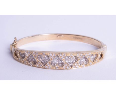 A 9ct bangle with heart design with diamonds, 20.30g.