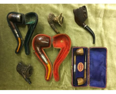 SILVER BANDED CASED SMOKING PIPES, CARVED BUFFALO BOWL PIPE AND TWO MEERSHAM PIPE BOWLS A/F