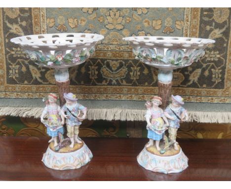 PAIR OF CONTINENTAL HANDPAINTED AND GILDED FIGURE FORM TAZZAS, BOTH STAMPED WITH BLUE R MARK TO BASE (AT FAULT), APPROXIMATEL