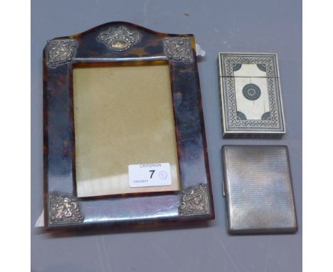 Victorian tortoiseshell frame, white metal mounted corners, a silver cigarette case with engine turned design, gilt washed in
