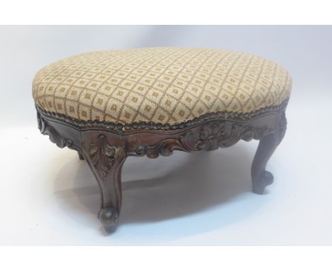 A Louis XV style mahogany foot stool, with cream and brown upholstery and raised on cabriole legs