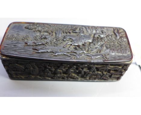 An 18th Century Chinese carved tortoiseshell trinket box. The top carved with a hunting scene. The rest carved with figures i