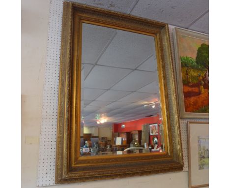 A 20th century gilt framed and bevelled glass mirror, 87x117cm