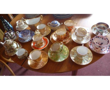 A collection of 19th Century hand painted cups and saucers