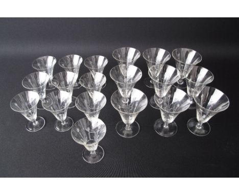 A collection of vintage hand-engraved footed wine glasses, trumpet shaped, comprising ten small H10cm and nine large H12cm. (