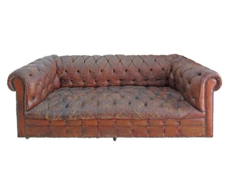 An English Chesterfield three seater brown leather sofa in need of restoration. W215cm, D90cm, H70cm.