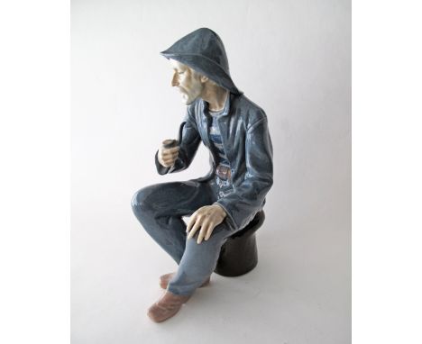 A Spanish Nao porcelain figure of a fisherman smoking a pipe, H38cm.