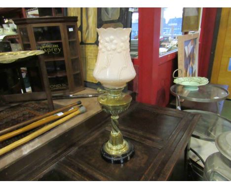 A Victorian oil lamp with brass base with foliate detail, half fluted brass reservoir, Juno burner with pink glass shade, 62c