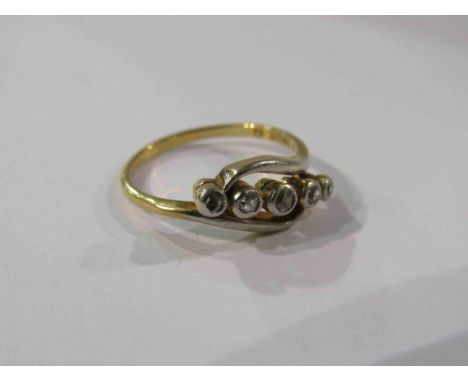 An 18ct gold five stone diamond crossover ring. Size N, 3.2g