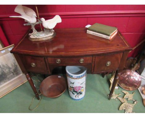 An early 19th Century mahogany bow front sideboard of small proportions, cross-banded in satinwood with three small drawers, 