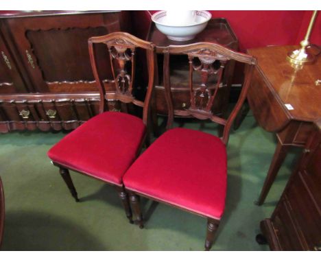 A set of four Victorian carved mahogany dining chairs on ring turned legs