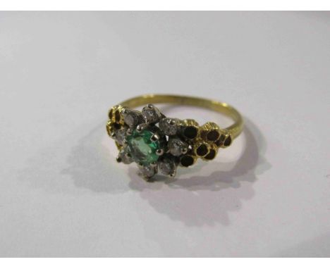 An 18ct emerald and diamond cluster ring. Size L/M