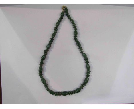 A green jade bead necklace, 60cm long