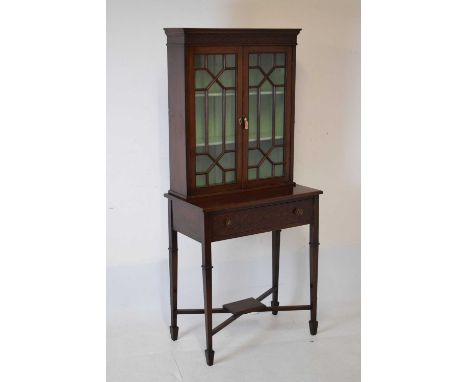 Edwardian mahogany Chippendale revival cabinet on stand, the upper stage having a pair of thirteen-pane astragal-glazed doors