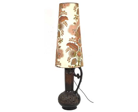 1970s pottery lamp, probably West German, the pierced and moulded body with scroll handle and internal light fitting, beneath