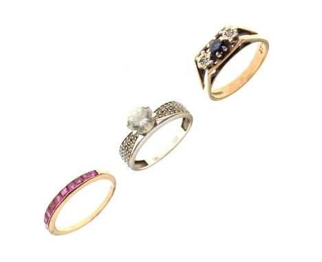 Three stone set dress rings, including a 9ct gold illusion set sapphire three stone ring, size O approx, a CZ single stone se