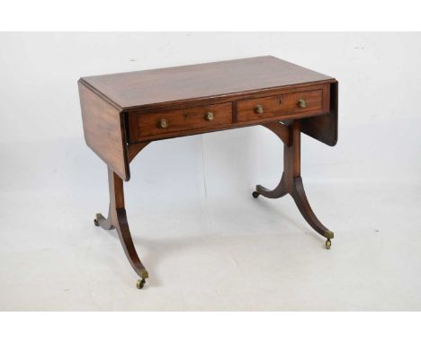 Early 19th Century mahogany sofa table, the moulded and criossbanded top and rounded flaps over two cockbeaded true drawers (