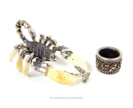 A Chinese white metal scorpion with bone pincers and legs together with a large Chinese white metal ring.