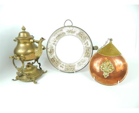 A decorative planished copper and brass powder flask, together with a Victorian copper plate warmer, and a brass spirit kettl