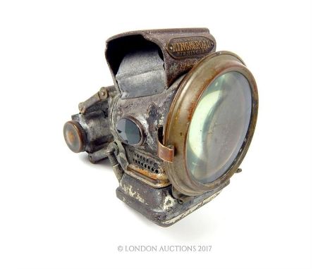 A vintage 'King of the Road' bicycle lamp with original faceted green and red glass lenses on either side of the central lamp