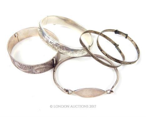 Five period sterling silver bangles to include a Charles Horner engraved bangle, Chester, 1955, and four other examples, Gros