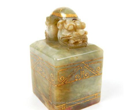 A Chinese jade seal with four character mark to its base; gilt paint decoration; 7cm high.