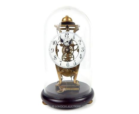A brass mantle clock which strikes on the hour, having an enamelled dial with Arabic numerals, contained within a glass dome 