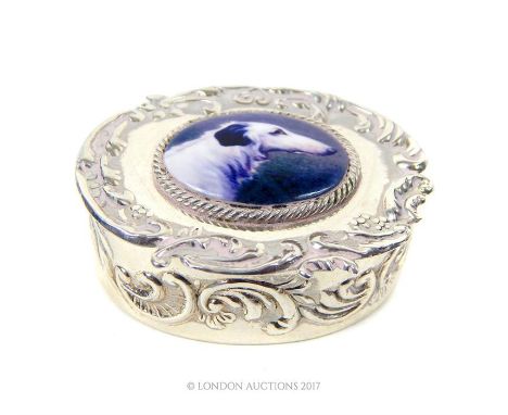 A Sterling silver embossed pill box with an enamel image of a dog.