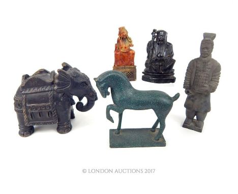 A group of five Oriental and Oriental style sculptural wares to include a carved, black stone sage with a staff on fitted bas