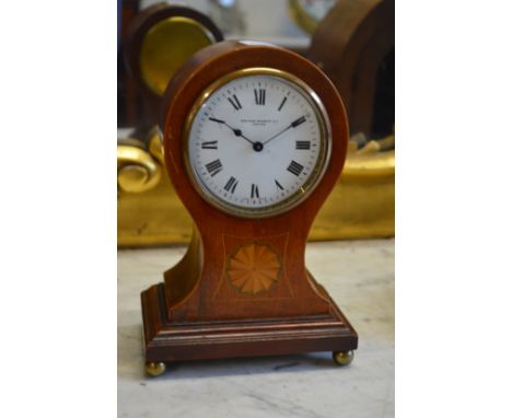 An Edwardian inlaid mahogany balloon shaped mantle clock, the enamel dial signed Sir John Bennett Ltd.