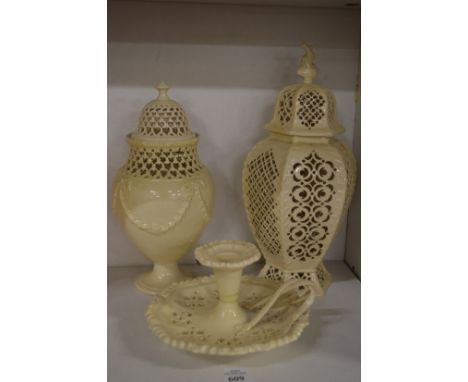 Three pieces of cream ware comprising of  two vases and covers and a chamber stick.