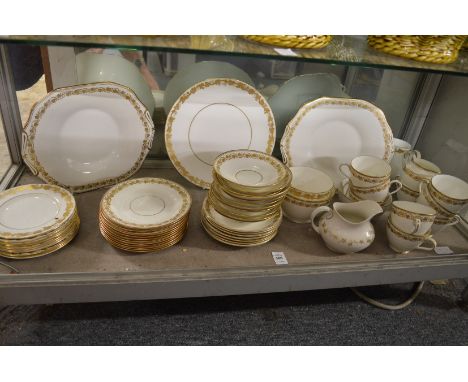 A quantity of gilt decorated tea cups and saucers.