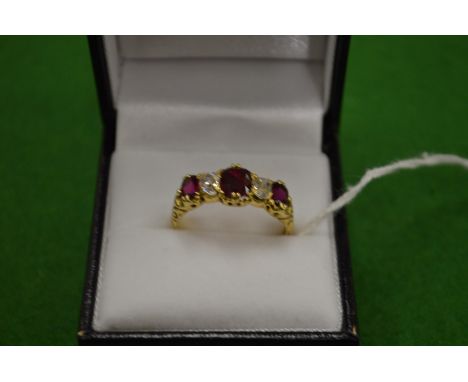 A good 18ct gold ring set with three rubies and two diamonds size T.