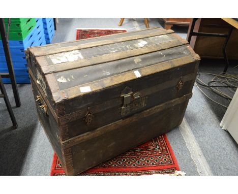 A dome topped trunk and a metal trunk.
