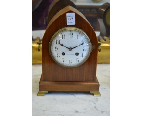 An Edwardian mahogany lancet shaped mantle clock, the enamel dial signed Maple and Co.