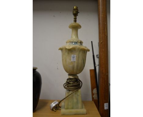 A large urn shaped alabaster table lamp.