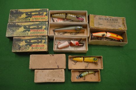 Six boxed carved and painted wood fishing lures by Pflueger &amp; Allcock &amp; Co 'Shurkatch' etc.