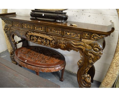 A large Chinese carved and gilded scroll end altar table.