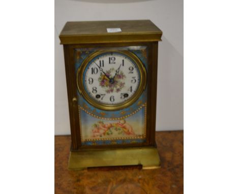 A brass mantle clock with Sevres style panels.