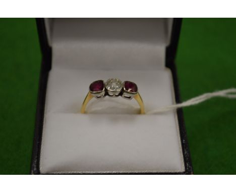 An 18ct gold diamond and ruby three stone ring size M½.