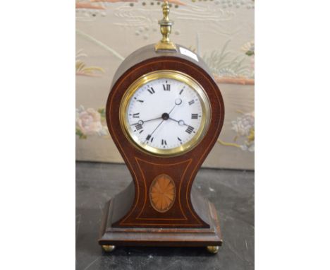 An Edwardian inlaid mahogany balloon shaped mantle clock with enamel dial, eight day movement with subsidiary seconds hand.