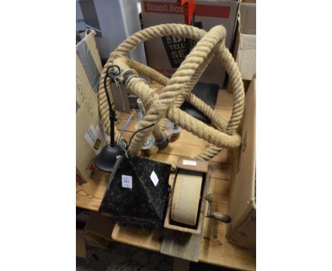 An old lantern, an unusual rope twist light, grinding wheel and another item.
