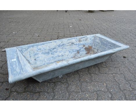 A galvanised rectangular planter/trough.