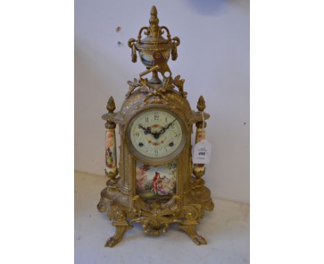 A decorative ormolu mantle clock.