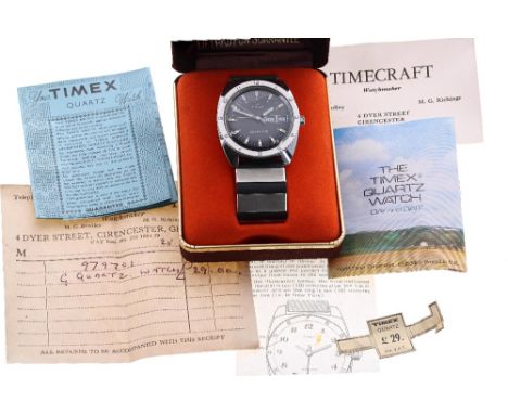 Q Timex Quartz Day Date stainless steel gentleman's wristwatch, circular black dial with baton markers, minute markers, day/d