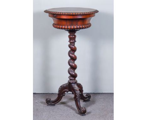 A Victorian Rosewood Circular Teapoy, the lifting lid enclosing two circular canisters and two cut glass mixing bowls, on spi