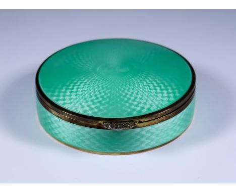 An Early 20th Century Silver Gilt and Green Enamel Circular Box, import marks HC Freeman Ltd. London 1923, the lid and sides 