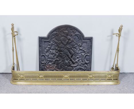 An Iron Fire Back, 20th Century, cast with a seated shepherd playing a flute, 24.5ins wide x 24.5ins high, a pierced brass fe